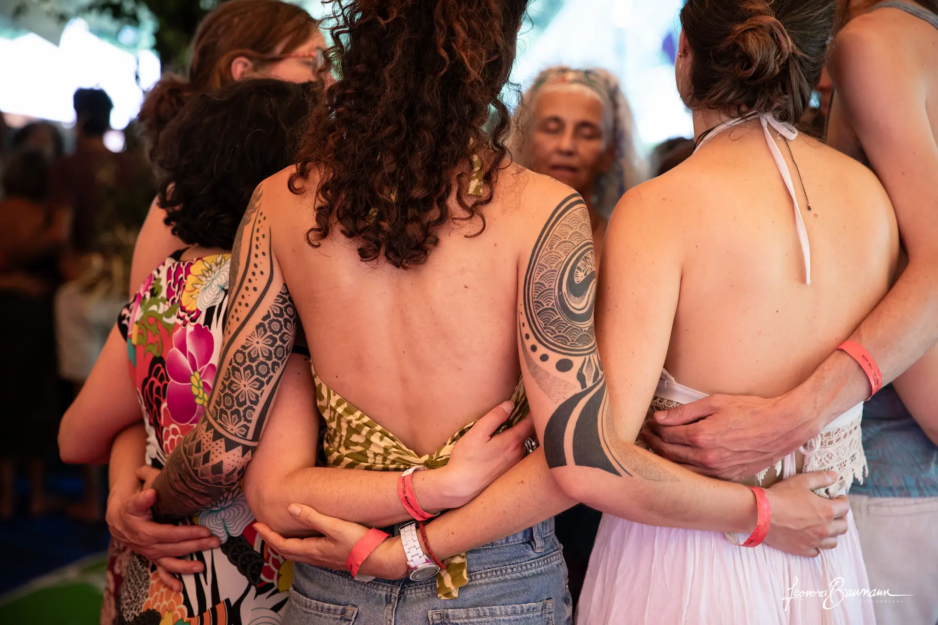 Cercle de danse au Festival Mantra Joie, participants enlacés dos à dos